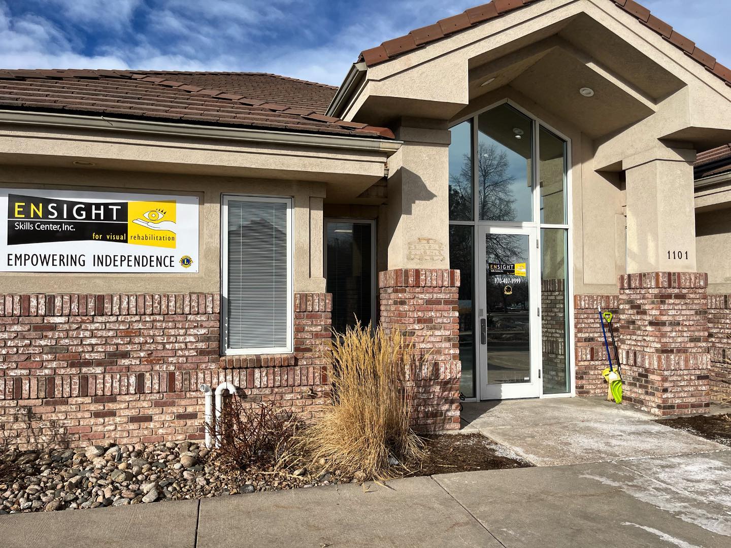 Tan and brick building with “Ensight Skills Center Sign” on the front